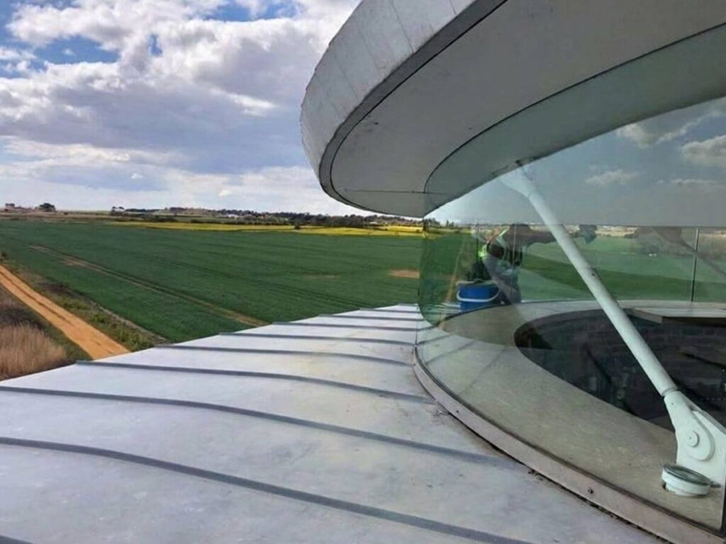 Curved architectural glass and roof glazing on a modern residential property