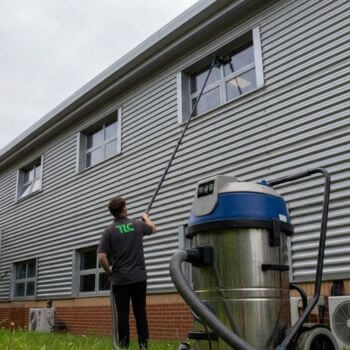 Commercial window cleaning being carried out on a business premises using professional equipment