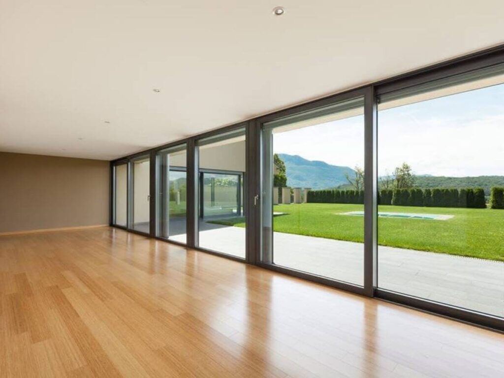 Modern home with large floor to ceiling windows overlooking countryside views.