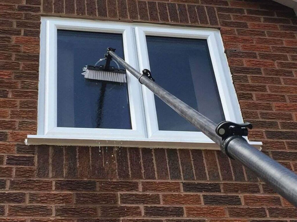 Water fed pole cleaning upper floor windows on a residential property