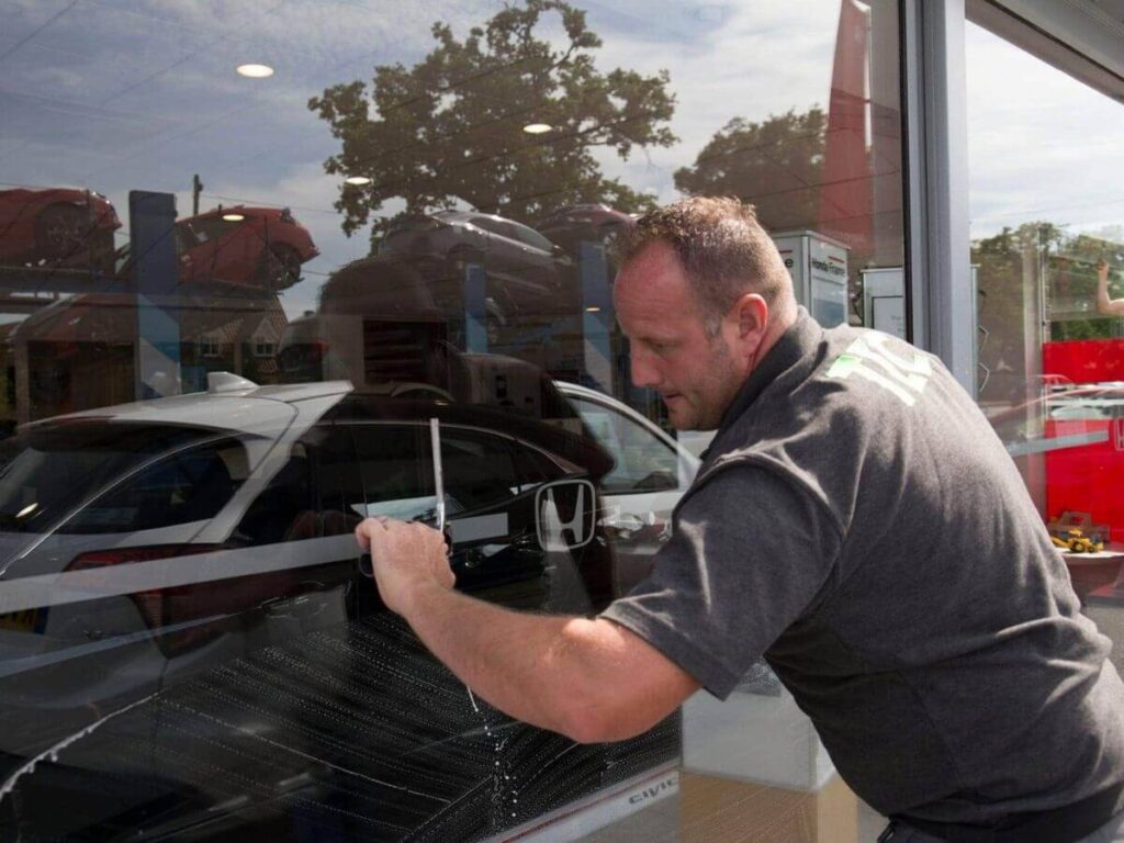 Commercial window cleaning technician cleaning exterior glazing.