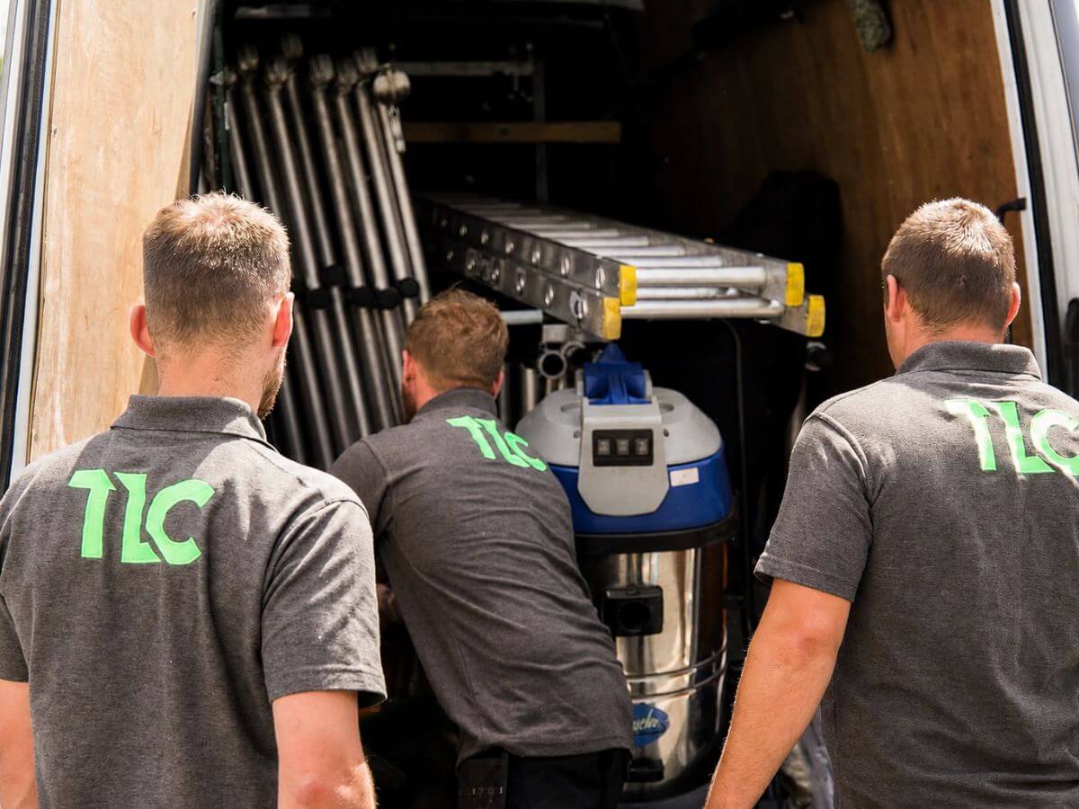 TLC Window Cleaning team preparing specialist cleaning equipment before starting work.
